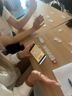 Teachers working with a tangible objects coding game